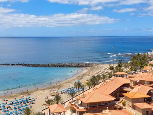 a view of a beach with people and the ocean at Frontal Ocean View Torres del Sol in Los Cristianos