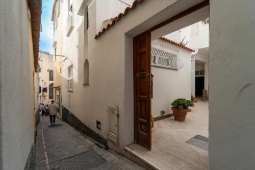 an open door to a alley with a person walking down it at Sunbliss Capri in Capri