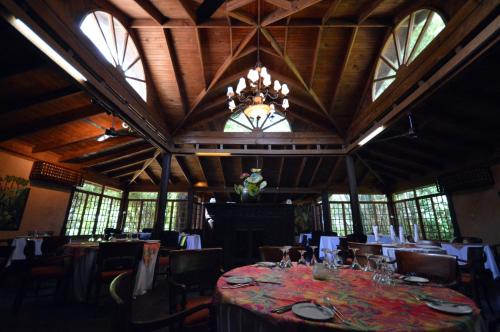 a large dining room with a table and a chandelier at Sunset at the Palms Resort - Adults Only - All Inclusive in Negril