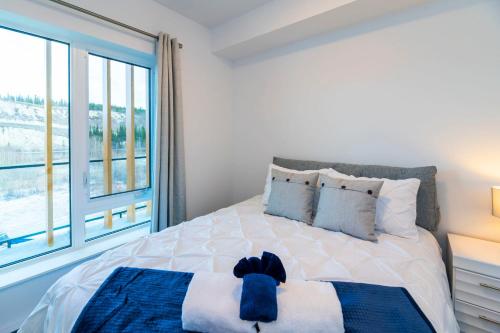 a bedroom with a bed with a large window at NN - The Current 2 - Downtown 1-Bed 1-Bath in Whitehorse