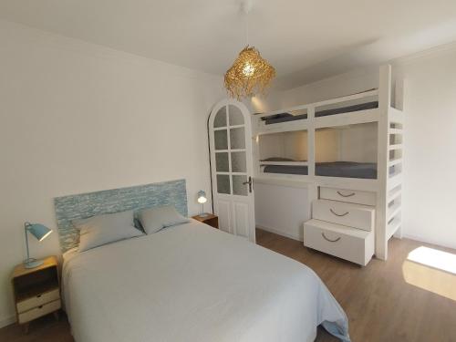 a white bedroom with a bed and bunk beds at Living Luzia in Santa Luzia