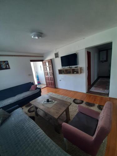a living room with a couch and a table at Apartman Goga in Pale