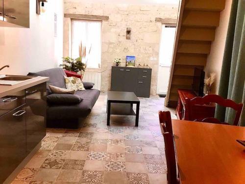 a living room with a couch and a table at Logement neuf et cosy proche centre ville in Chinon