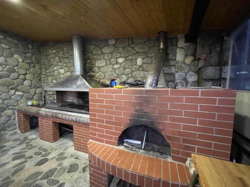 a brick oven in a room with a stone wall at HOME 12 in Librazhd