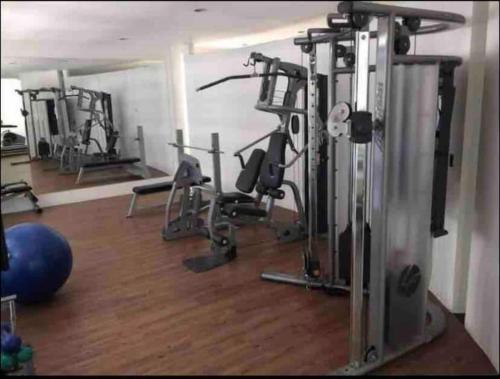 a gym with several treadmills and machines at Flat em Santos no Gonzaga a três quadras da praia in Santos