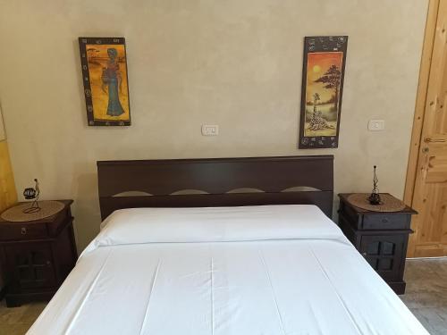 a bedroom with a large bed with two night stands at Fodor in Avola