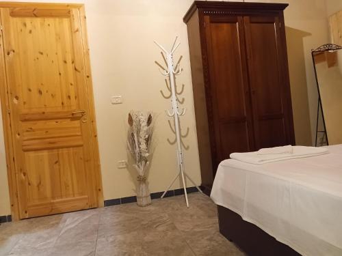 a bedroom with a bed and a skeleton on the wall at Agriturismo PALMERI in Avola