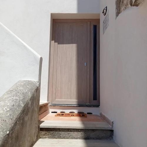 a wooden door on the side of a stairs at Domus Julia in Furore