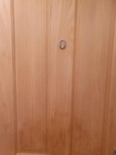 a wooden door with a lock on it at Tavern Court Shared Facilities in Manchester
