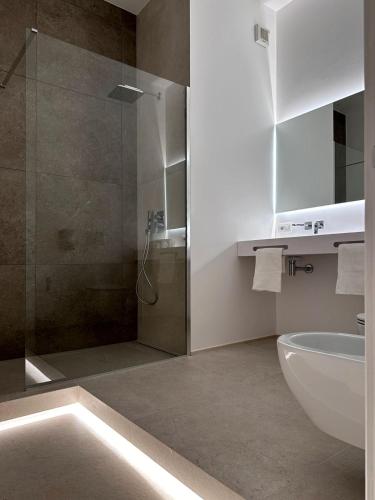a bathroom with a shower and a toilet and a sink at Ottanta5 Private Rooms in Messina