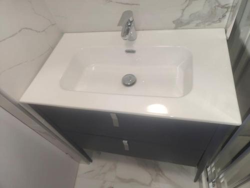 a white sink in a bathroom with a counter at Charmante maison in Niort