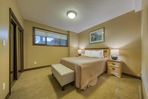 a bedroom with a large bed and a window at Marble Canyon in Fairmont Hot Springs