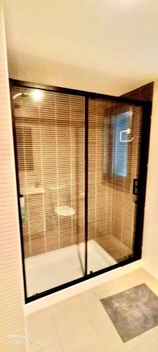 a large glass window in a room with a bathroom at Malpica Vistas in Malpica