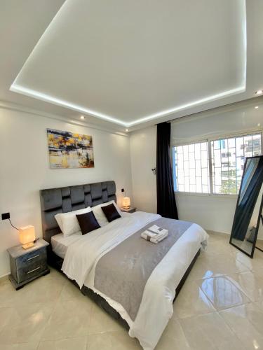 a bedroom with a large bed in a room at Lovely 2 bedroom apartment in Rabat