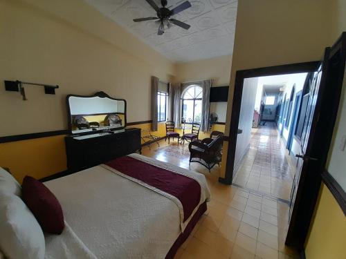 a bedroom with a large bed and a mirror at Hotel Santo Tomas / Historical Property in San José
