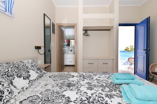 a bedroom with a bed and a view of the ocean at Niko's Beach Suites Νο2 in Agia Marina Aegina