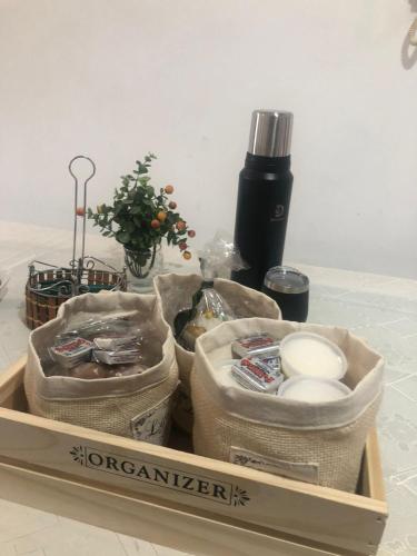 a wooden tray with three bags of food on a table at Departamento Citrino in Godoy Cruz