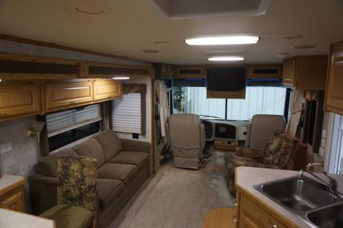 an rv living room with a couch and a sink at STAY IN VIEQUES FOR LESS RV ONE BED STUDIO APARTMENT - KITCHEN - DINING - PRIVATE BATh - NOT FOR DRIVING in Vieques