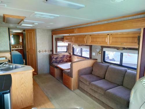 an interior of an rv with a couch and a sink at STAY IN VIEQUES FOR LESS RV ONE BED STUDIO APARTMENT - KITCHEN - DINING - PRIVATE BATh - NOT FOR DRIVING in Vieques