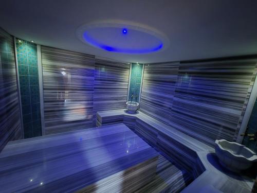 a large swimming pool in a bathroom with a blue light at Villa Ladybug Unique design of your dreams in Foca