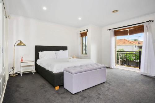 a bedroom with a bed and a chair and a window at Spacious Home in Newport in Newport