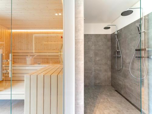 a bathroom with a shower with a glass door at Riesner Alpenlodge in Donnersbachwald