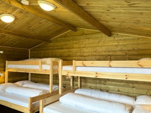 a room with three bunk beds in a cabin at Winjum Cabin Aurland Stegastein in Aurland