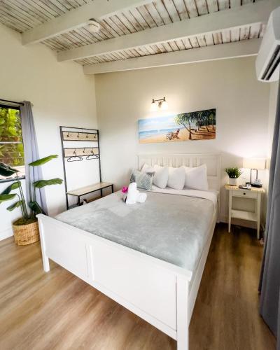 a bedroom with a large white bed in a room at La Jamaca - An Island Vibe Hotel in La Parguera