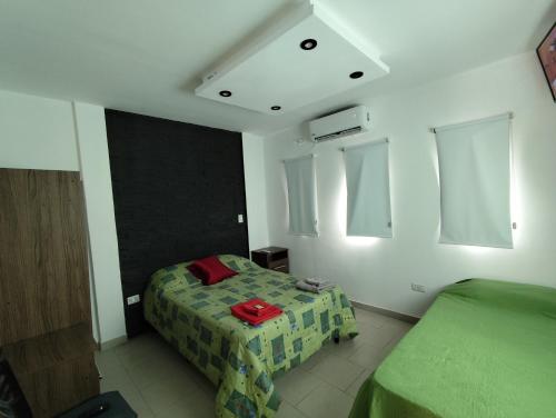 um quarto com 2 camas num quarto com janelas em La Emilia em Cafayate