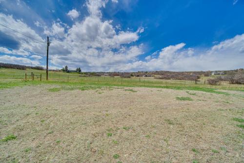 an empty field with a telephone pole in a field at 2 Mi to Dtwn Castle Rock Home with Furnished Patio in Castle Rock