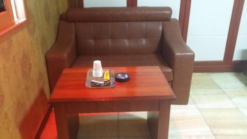 a coffee table with a couch in a room at Plus Motel in Busan
