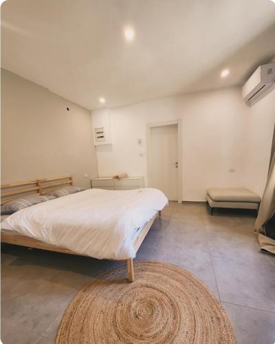 um quarto com uma cama grande e um tapete em בית מקסים בלב העיר em Tel Aviv