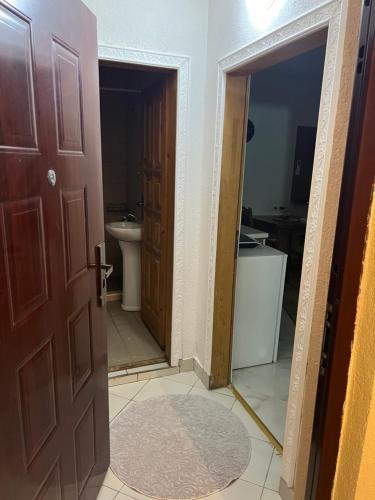 a bathroom with a toilet and a door with a mirror at SARAH APARTMENTS in Gusinje