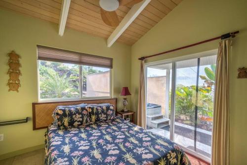 a bedroom with a bed and a large window at The Pineapple Express Hot Tub Volcano 65 Mi Away in Papa Bay Estates