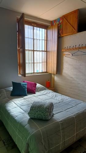 a bedroom with a large bed with a pillow on it at El Parralito in Mendoza