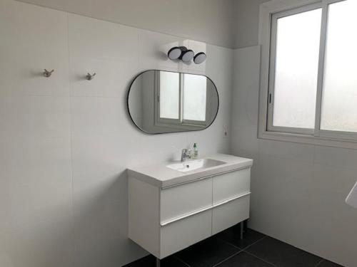 a white bathroom with a sink and a mirror at Maison lumineuse avec jardin privatif, proche châteaux de la Loire, tennis gratuit et charme historique - FR-1-581-69 in Châteaudun