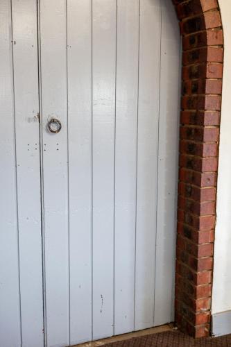 a white garage door next to a brick wall at Converted Historic Hotel in Finley, Sleeps 25 in Finley