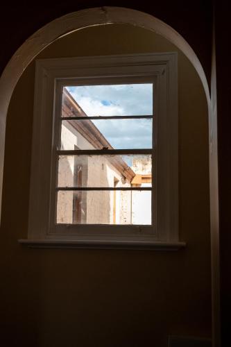 an arched window in a room with a building at Converted Historic Hotel in Finley, Sleeps 25 in Finley