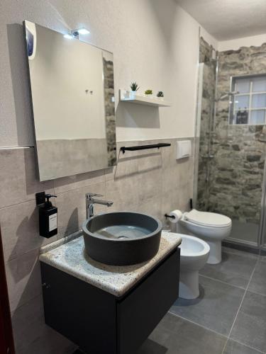 a bathroom with a sink and a toilet at Casa Stewart - Ponente in Geremèas