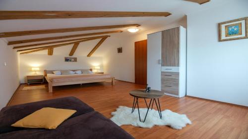 a living room with a bed and a table at Apartments with parking space Lopar, Rab - 22674 in Lopar