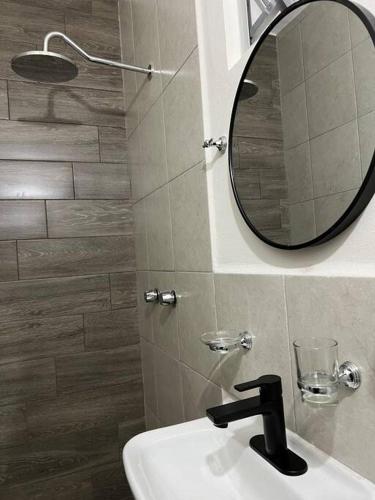 a bathroom with a sink and a mirror on the wall at Depa Ye in El Alcanfor