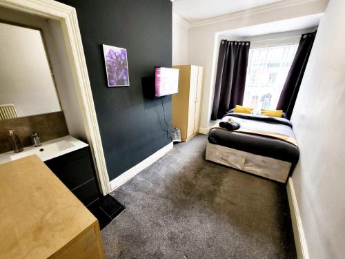 a small room with a bed and a sink at Stay Sleep Rest - De Grey in Hull