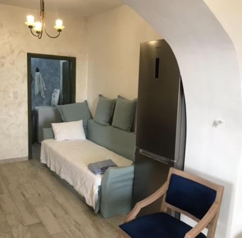 a bedroom with a bed and a chair in it at Elafonisi Villa above the Beach in Elafonisi