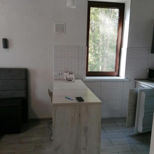 a kitchen with a wooden island in a room at КарпатиКайзервальд. in Karpaty