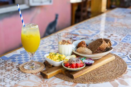 a tray of breakfast foods and a glass of orange juice at Curaçao Gardens in Willemstad