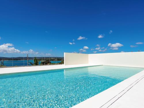 a swimming pool in a villa with a view of the water at Private condo Kourijima by Coldio Smart Resort in Nakijin