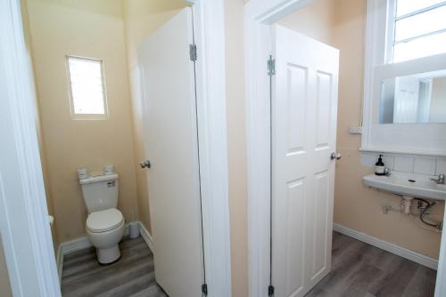 a bathroom with a toilet and a sink at Converted Historic Hotel in Finley, Sleeps 25 in Finley