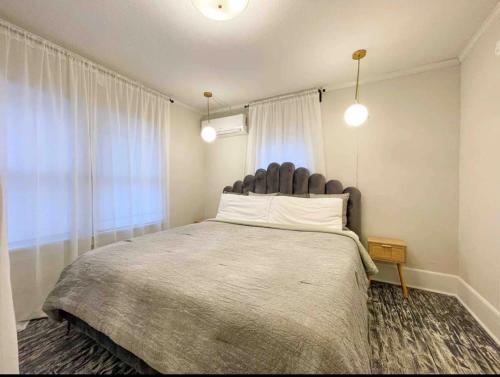 a bedroom with a large bed and a window at Two bedroom house in Downtown Asheville in Asheville