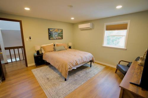 a bedroom with a bed with a rug and a window at The Edamame House 