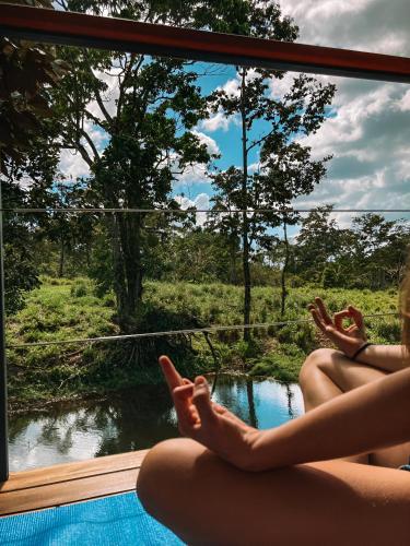two girls sitting on the side of a pool looking out a window at a river at Rincón Sereno San Carlos in La Marina